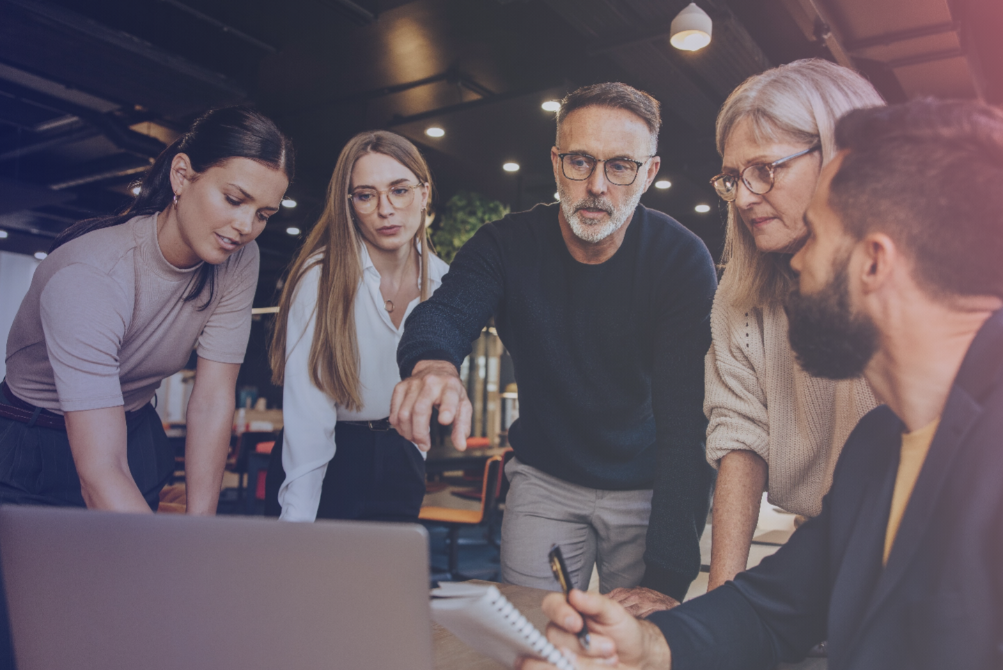 A group of people looking at a computer 