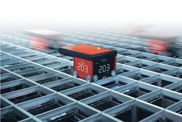 Automated warehouse system with several red robotic units moving rapidly on a grid structure, handling storage bins for efficient order fulfillment