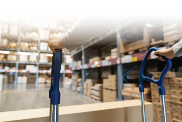 Person pushing a shopping trolley in a furniture warehouse, picking items from the shelves