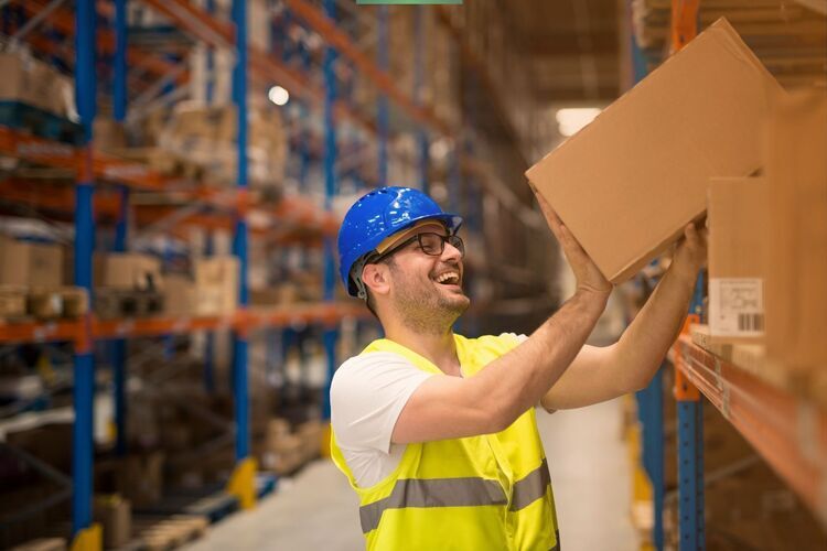 warehouse-worker-blue-helmet-carrying-box-fade