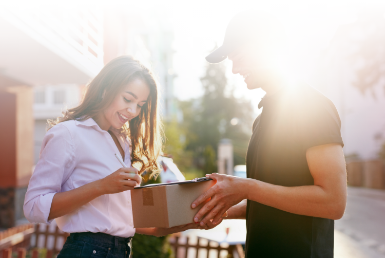 woman signs package delivery from a courier