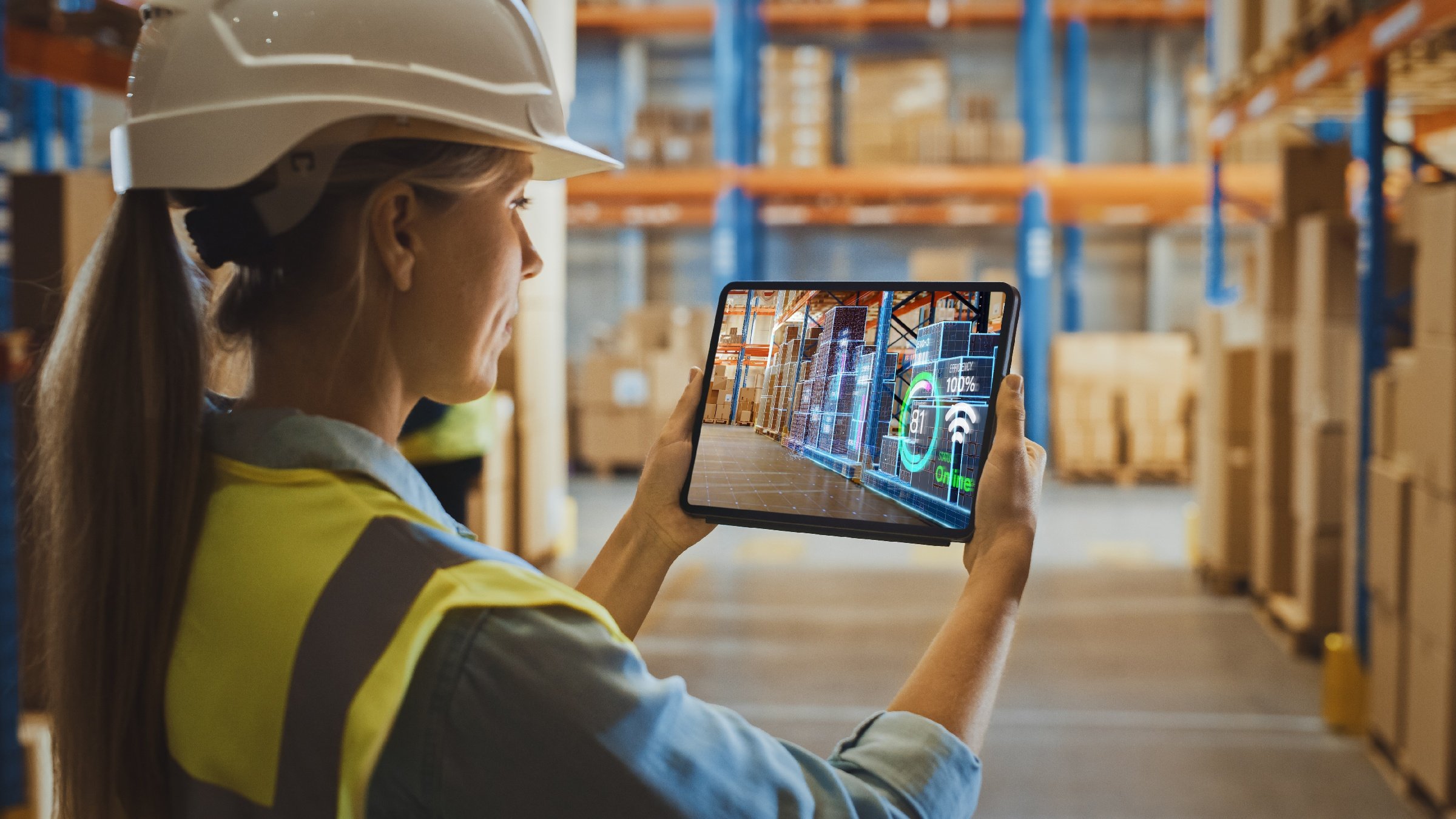 Female using digital twin supply chain warehouse reality application an a tablet