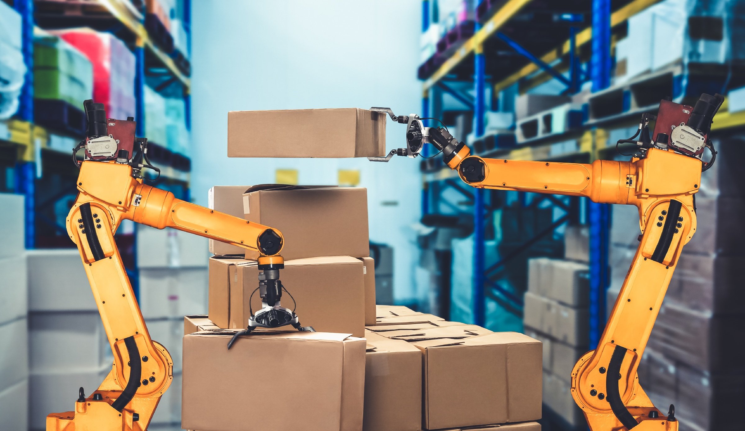 Two robot arms are working together in a warehouse after a successful WMS implementation