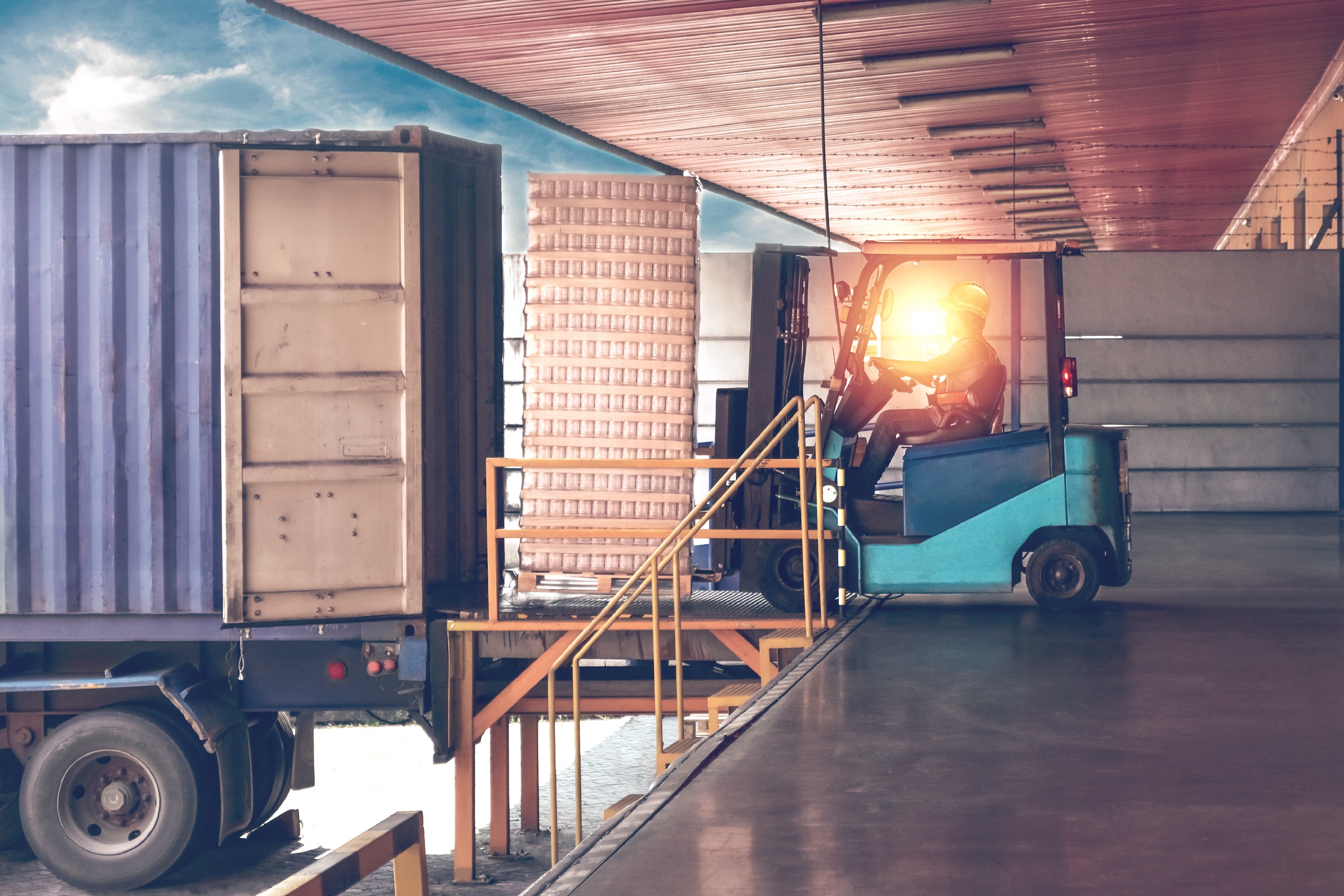 forklift loading parcels into a truck