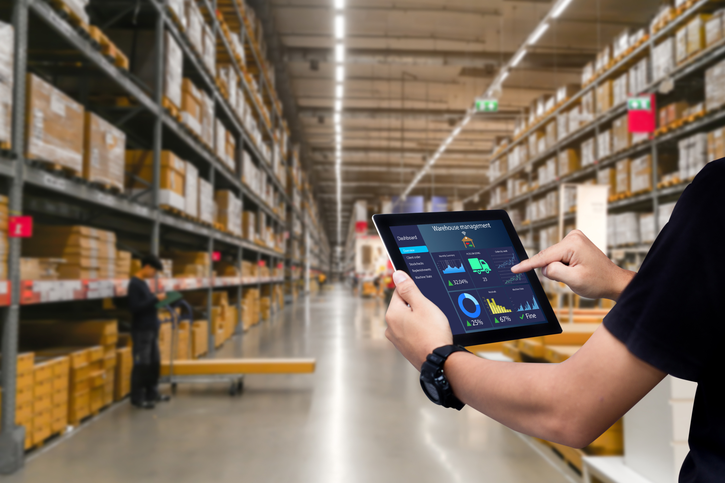 Hands holding a tablet visualizing digital twin warehouse.