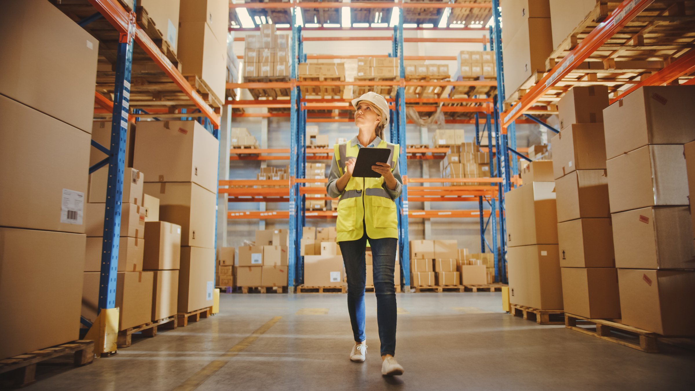 Woman walk in warehouse and writing warehouse optimization tips